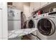 Well-equipped laundry room with front-load washer and dryer and ample cabinet space at 3562 E Harvard Ct, Gilbert, AZ 85234