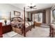 Spacious main bedroom featuring a four-poster bed, ceiling fan, and plush carpeting at 3562 E Harvard Ct, Gilbert, AZ 85234