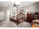 Cozy main bedroom featuring carpet, neutral walls, a four-poster bed, and wooden furnishings at 3562 E Harvard Ct, Gilbert, AZ 85234