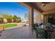 Inviting outdoor patio with stone pavers, a ceiling fan, and lush landscaping at 3562 E Harvard Ct, Gilbert, AZ 85234