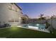 View of the home's exterior and refreshing swimming pool with lush landscaping at 366 E Mule Train Trl, San Tan Valley, AZ 85143