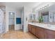 Bathroom features double sinks, a large mirror, tile floors, a walk-in shower, and a walk-in closet at 366 E Mule Train Trl, San Tan Valley, AZ 85143