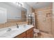 Bathroom with double sinks, tile floors, a shower with tile surround, and a toilet at 366 E Mule Train Trl, San Tan Valley, AZ 85143