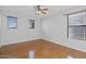 Bedroom with window, fan, and wood floors at 366 E Mule Train Trl, San Tan Valley, AZ 85143