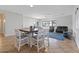 Spacious and bright living room with tile flooring and wooden dining table at 366 E Mule Train Trl, San Tan Valley, AZ 85143