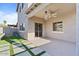 Backyard patio with a ceiling fan, and artificial turf with stone paver accents at 366 E Mule Train Trl, San Tan Valley, AZ 85143