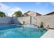 Sparkling backyard pool, landscaped surroundings, and a tiled water feature on a private wall at 366 E Mule Train Trl, San Tan Valley, AZ 85143