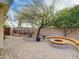 Relaxing backyard featuring a fire pit, paver patio, and a seating area perfect for outdoor gatherings at 4122 E Burnside Trl, Cave Creek, AZ 85331