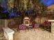 Cozy backyard patio with a fireplace, comfortable seating and lush landscaping for outdoor entertaining and relaxing at 4122 E Burnside Trl, Cave Creek, AZ 85331