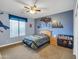 View of cozy bedroom features themed decor, ceiling fan, and carpet flooring at 4122 E Burnside Trl, Cave Creek, AZ 85331