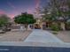 Beautiful home exterior with a spacious driveway and desert landscaping at twilight at 4122 E Burnside Trl, Cave Creek, AZ 85331