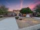 Elegant exterior of a home with a large driveway and desert landscaping at dusk at 4122 E Burnside Trl, Cave Creek, AZ 85331