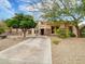 Charming front exterior featuring desert landscaping, mature trees, basketball hoop and a spacious driveway at 4122 E Burnside Trl, Cave Creek, AZ 85331