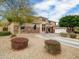 Beautiful two-story home with a well-manicured front yard, desert landscaping, and a circular driveway at 4122 E Burnside Trl, Cave Creek, AZ 85331