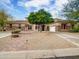 Charming front exterior featuring desert landscaping, mature trees and a spacious driveway at 4122 E Burnside Trl, Cave Creek, AZ 85331