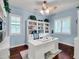 A dedicated home office featuring blue walls, built-in shelving, and ample natural light at 4122 E Burnside Trl, Cave Creek, AZ 85331