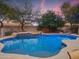 Sparkling pool with a built-in spa and rock features, creating a luxurious backyard retreat at 4122 E Burnside Trl, Cave Creek, AZ 85331