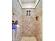 A beautifully tiled walk-in shower room with dual shower heads, bronze fixtures, and a built-in shower niche at 4122 E Burnside Trl, Cave Creek, AZ 85331