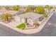 Aesthetic aerial view of a well-landscaped home boasting a three-car garage, sidewalk, and a cozy, inviting facade at 44 W Teakwood Pl, Chandler, AZ 85248