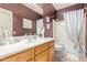 Bathroom showcases a vanity with a large mirror, tub, and toilet at 44 W Teakwood Pl, Chandler, AZ 85248