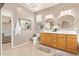 Bathroom featuring double sinks, soaking tub, glass block window, and tiled floor at 44 W Teakwood Pl, Chandler, AZ 85248