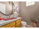 Powder room with granite countertop, unique sink, and a round mirror at 44 W Teakwood Pl, Chandler, AZ 85248