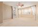 Spacious bedroom features plush carpet, neutral walls, a ceiling fan, and sunny windows with white shutters at 44 W Teakwood Pl, Chandler, AZ 85248