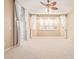 Spacious bedroom features plush carpet, neutral walls, a ceiling fan, and sunny windows with white shutters at 44 W Teakwood Pl, Chandler, AZ 85248