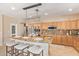 Large kitchen with stainless steel appliances, granite countertops, a center island, and a decorative light fixture at 44 W Teakwood Pl, Chandler, AZ 85248