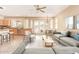 Open-concept living room featuring a kitchen, dining area, and a comfortable seating arrangement with natural light at 44 W Teakwood Pl, Chandler, AZ 85248