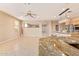 Open concept living area featuring a kitchen, tile floors, and neutral colored walls at 44 W Teakwood Pl, Chandler, AZ 85248