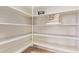 Pantry with white shelves and modern design with ample storage space at 44 W Teakwood Pl, Chandler, AZ 85248