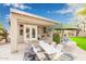 Covered patio with outdoor dining set, hanging chair, and garden views at 44 W Teakwood Pl, Chandler, AZ 85248