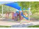 Community playground area features colorful play structures and a shaded seating area for residents to enjoy outdoor activities at 44 W Teakwood Pl, Chandler, AZ 85248