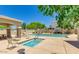 Sparkling community pool and hot tub with ample seating and well-maintained landscaping at 44 W Teakwood Pl, Chandler, AZ 85248