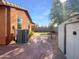 Backyard featuring a brick pathway, small storage shed, and minimal landscaping at 45997 W Windmill Dr, Maricopa, AZ 85139