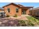 A private backyard featuring desert landscaping, a covered patio, and low-maintenance brick at 45997 W Windmill Dr, Maricopa, AZ 85139