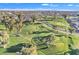 Expansive aerial view of the beautifully landscaped golf course with winding paths and mature trees at 4720 E Flossmoor Cir, Mesa, AZ 85206