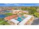 Aerial view of the community clubhouse with a pool, and tennis courts at 4720 E Flossmoor Cir, Mesa, AZ 85206