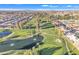 Picturesque aerial shot of a golf course with mature trees and a pond amid residential community at 4720 E Flossmoor Cir, Mesa, AZ 85206