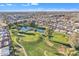 Aerial view showcases a golf course and pond surrounded by a well-maintained residential community at 4720 E Flossmoor Cir, Mesa, AZ 85206