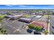 Community center aerial featuring mature landscaping, tennis courts, pool, and parking lot at 4720 E Flossmoor Cir, Mesa, AZ 85206