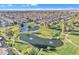 Scenic aerial view of a golf course community with lush green fairways and tranquil water features at 4720 E Flossmoor Cir, Mesa, AZ 85206