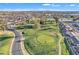 Aerial view of golf course, showcasing manicured greens, mature trees, and winding cart paths at 4720 E Flossmoor Cir, Mesa, AZ 85206