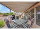 Shaded backyard patio offers a dining set and scenic views of the desert landscape beyond at 4720 E Flossmoor Cir, Mesa, AZ 85206