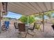 Patio area featuring a seating set and a view of a lush backyard with an orange tree at 4720 E Flossmoor Cir, Mesa, AZ 85206