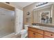 Well-lit bathroom features a granite countertop vanity, neutral walls, and a shower with a glass door for modern comfort at 4720 E Flossmoor Cir, Mesa, AZ 85206