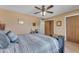 Cozy bedroom featuring carpeted floors, a ceiling fan, and ample closet space, providing both comfort and functionality at 4720 E Flossmoor Cir, Mesa, AZ 85206