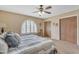 Well-lit bedroom featuring a ceiling fan, carpet, and a window with shutters for a comfortable and inviting living space at 4720 E Flossmoor Cir, Mesa, AZ 85206