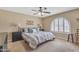 Comfortable bedroom with a ceiling fan, a window, and carpeted floors that provide a serene and inviting retreat at 4720 E Flossmoor Cir, Mesa, AZ 85206